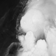 Infrared satellite frame of a disorganized tropical storm, bright convective cloud tops against dark ocean.